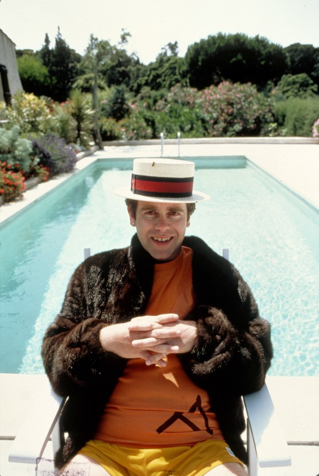 Elton John poses by a pool circa 1981