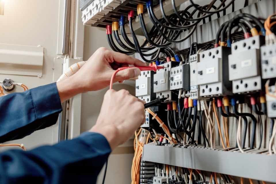 a man is working on an electrical panel with a sticker that says ' a ' on it