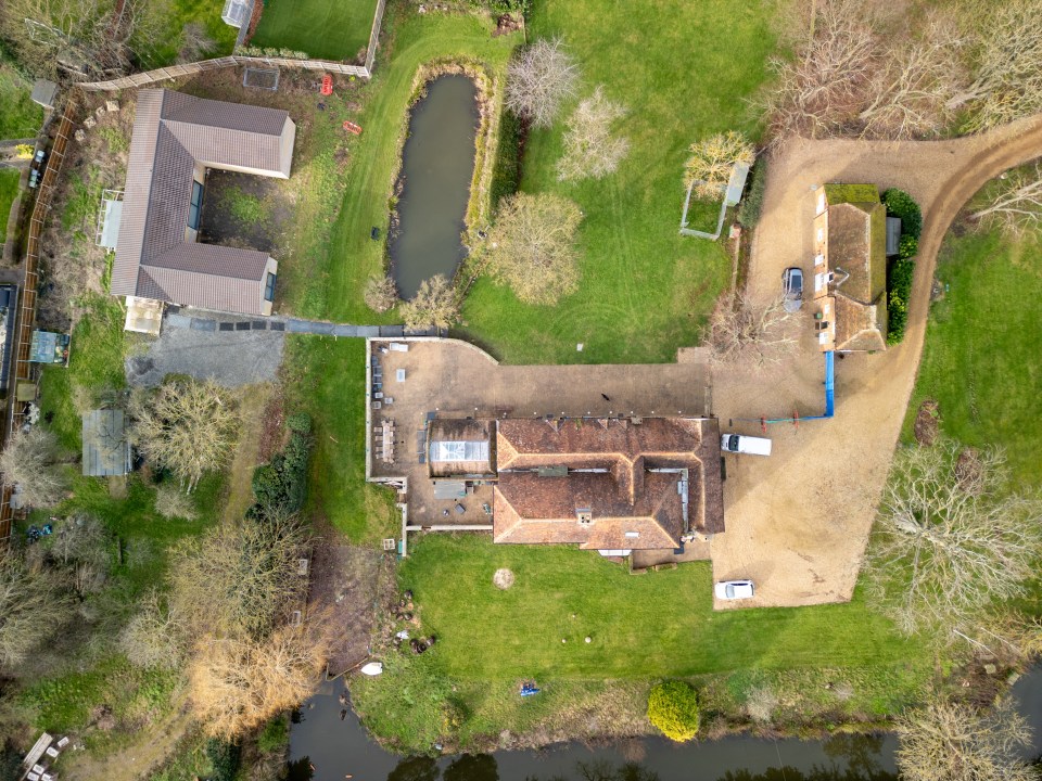 an aerial view of a house with a white truck parked in front of it