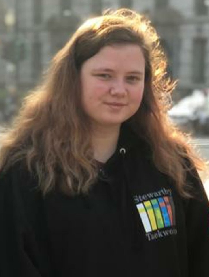 a young woman with long hair is wearing a black hoodie .