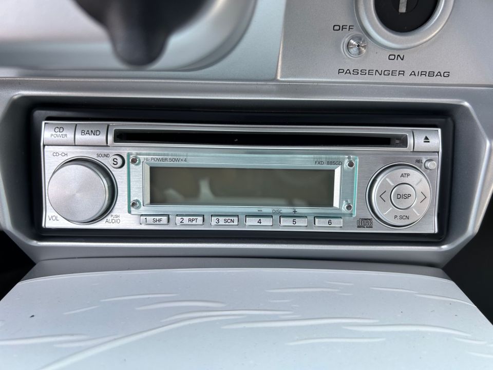 a passenger airbag button is next to a cd player