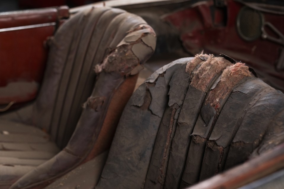 the back seat of an old car has a lot of dust on it