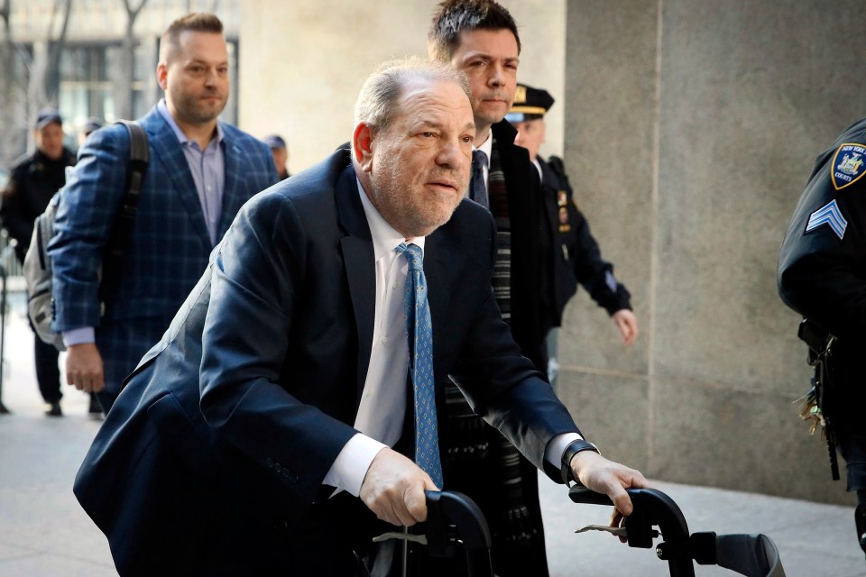 a man in a suit and tie is pushing a wheelchair