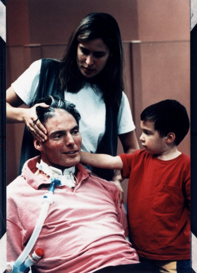 a man in a pink shirt has an oxygen mask around his neck