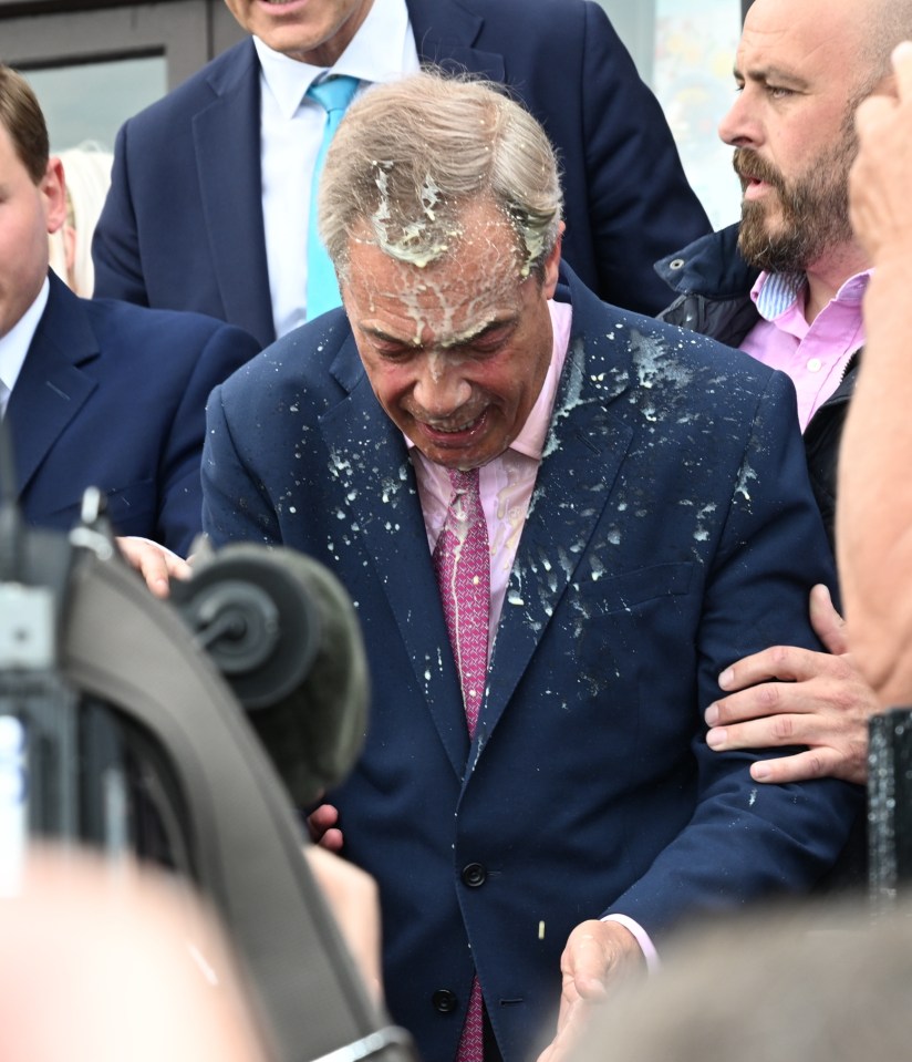 a man in a suit and tie is covered in white liquid