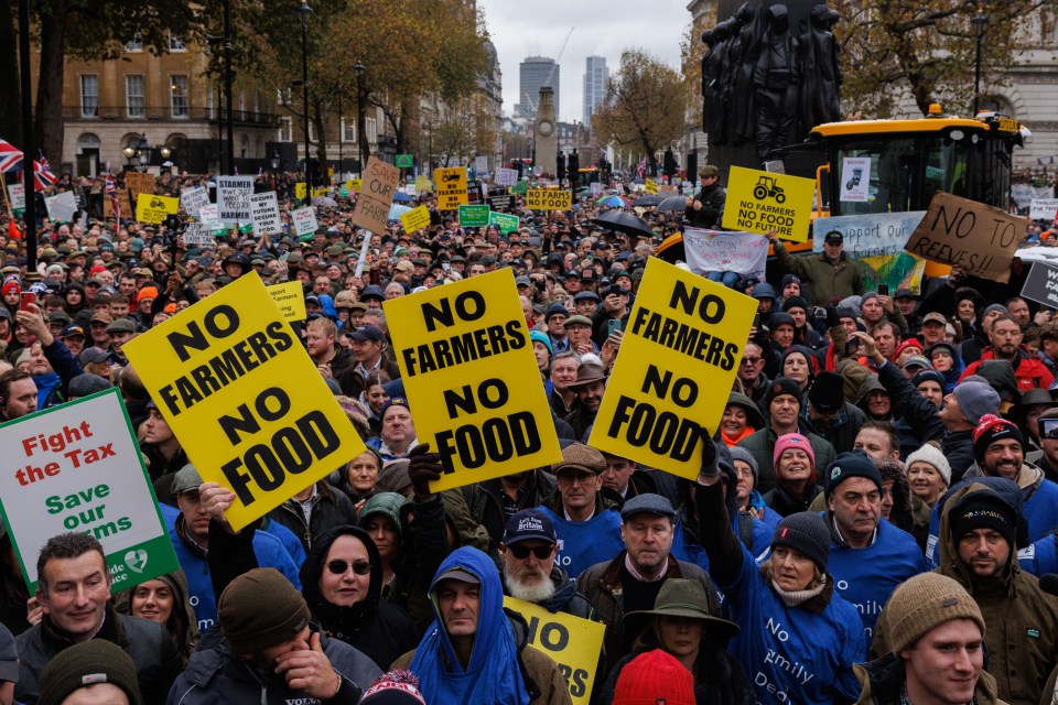a crowd of people holding signs that say no farmers no food
