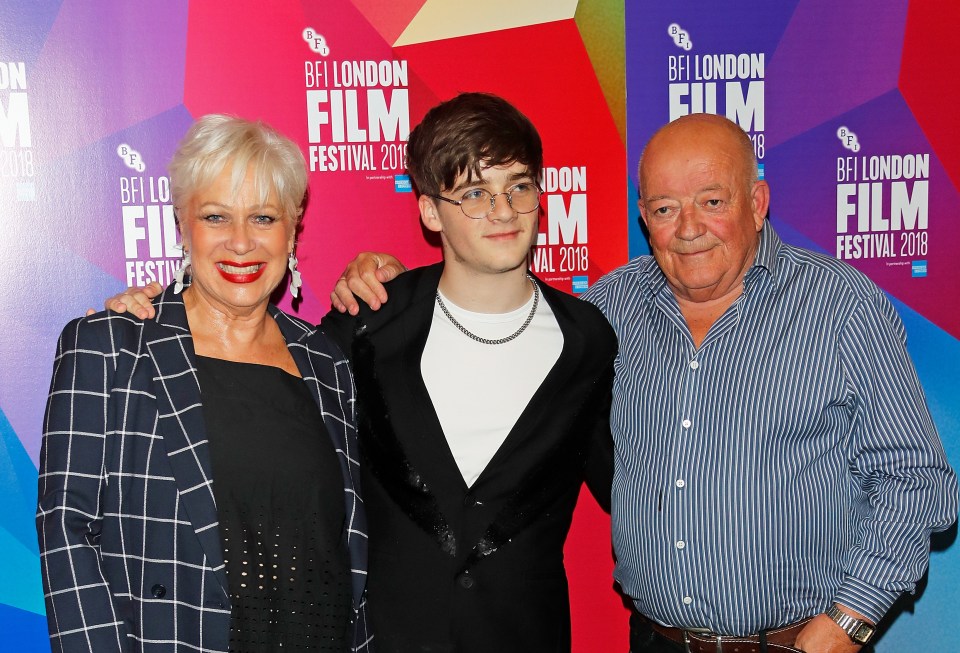 three people pose for a picture in front of a bfi london film festival sign
