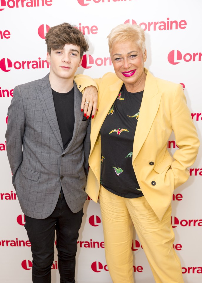 a woman in a yellow suit stands next to a boy in a grey suit