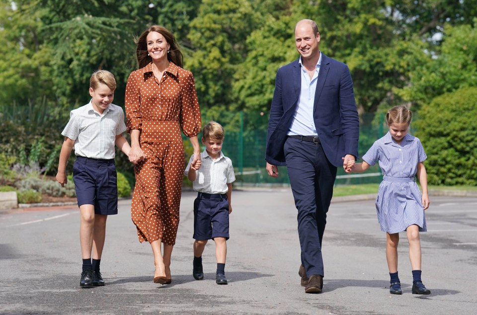 Prince William, Kate Middleton, and their three children walking to school.