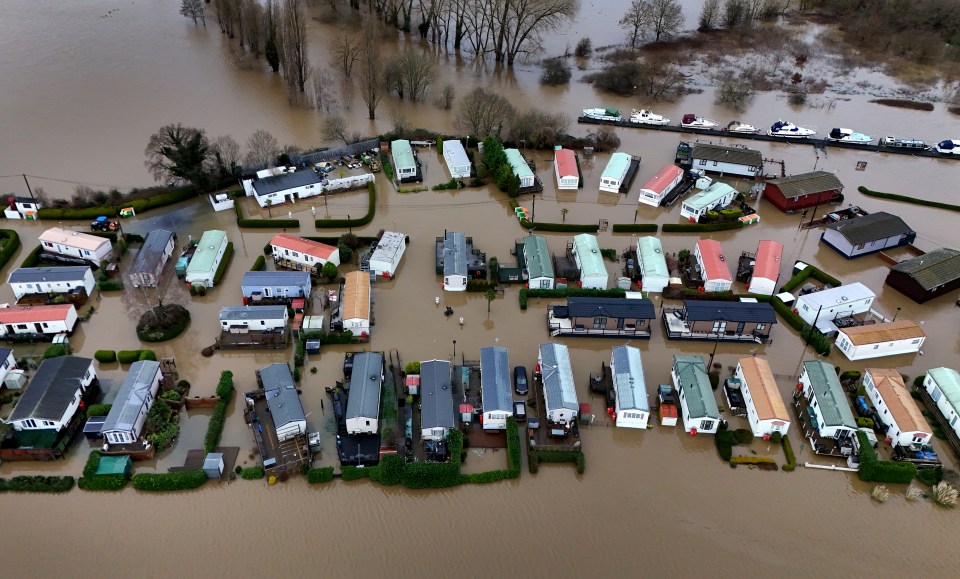 Aerial view of floodwaters inundating a caravan park.