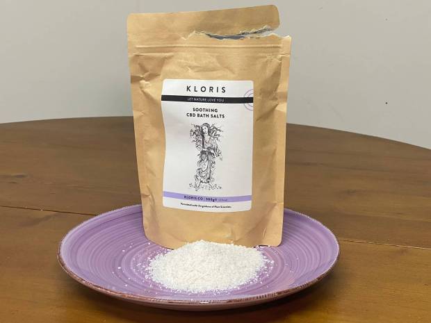 Kloris soothing CBD bath salts in a bag and on a plate.