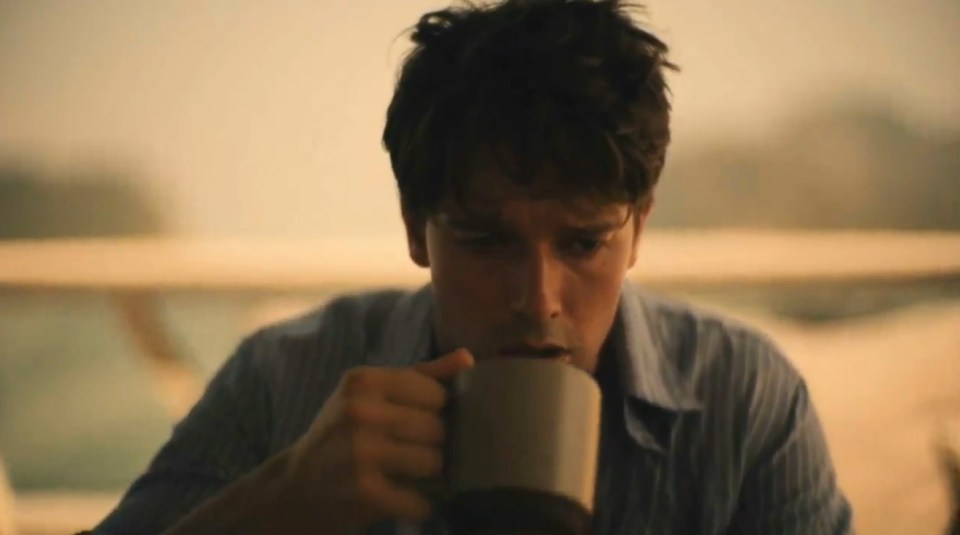 Man drinking from a mug.