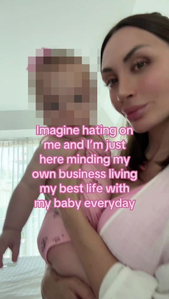 Woman holding baby, text overlay: "Imagine hating on me and I'm just here minding my own business living my best life with my baby everyday"