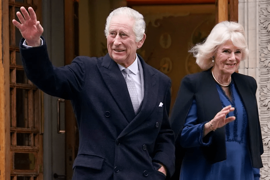 King Charles III and Camilla, Queen Consort, waving to the public.