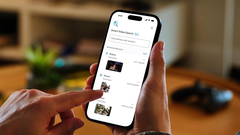 Smartphone displaying smart video search results for "pizza delivery with red shirt".