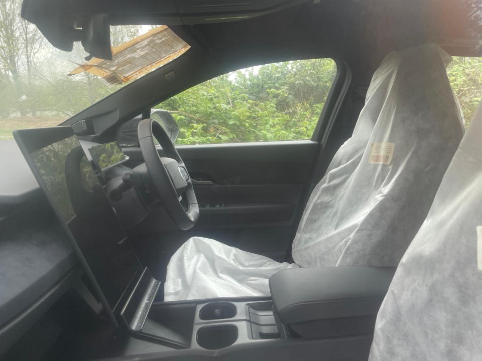 Interior of a new, unsold electric 4x4 with protective coverings on the seats.