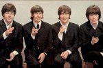 The Beatles pointing at the camera.