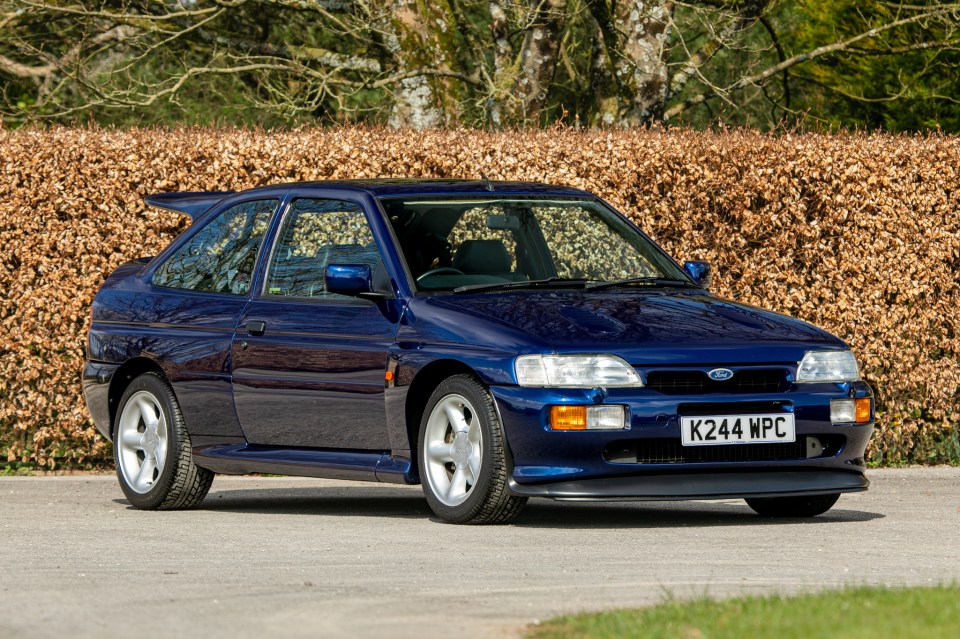 A blue 1993 Ford Escort RS Cosworth Lux Big Turbo.