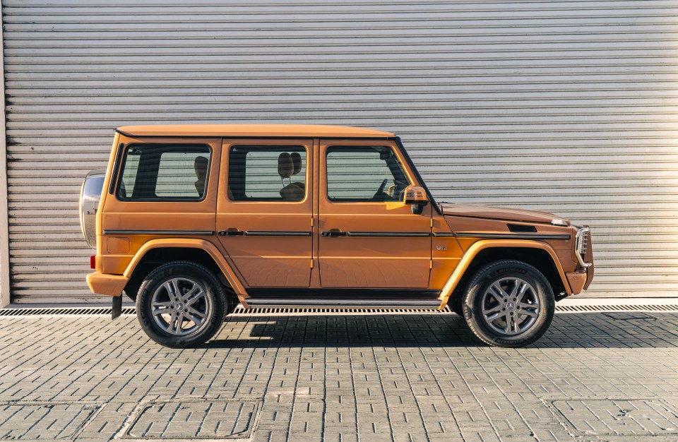 Terracotta Mercedes-Benz G 500 SUV parked outdoors.