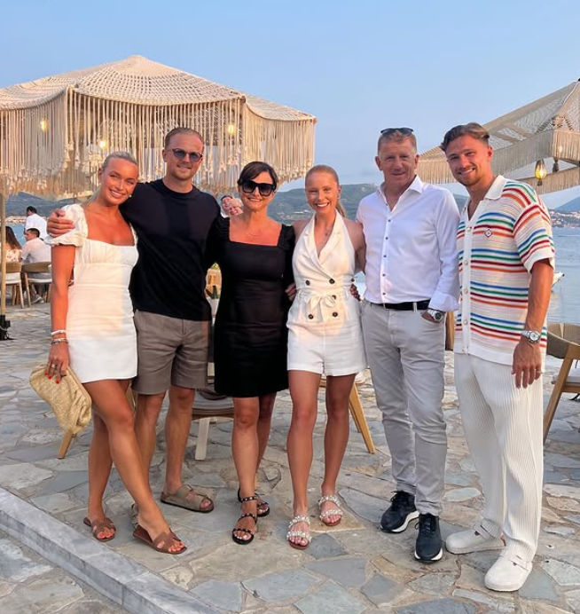 Group photo of six people at an outdoor restaurant.