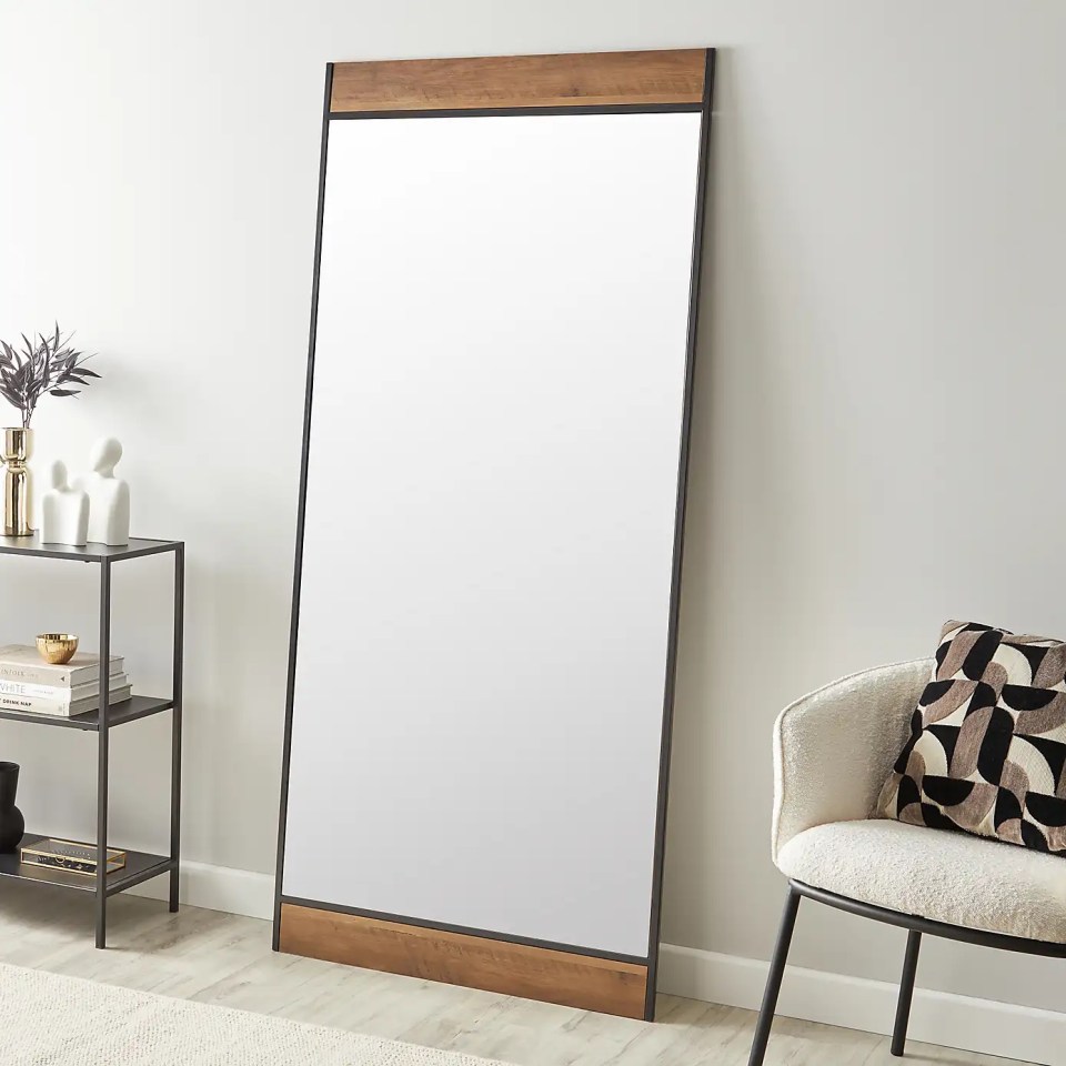 Full-length leaner mirror with a wood and metal frame.