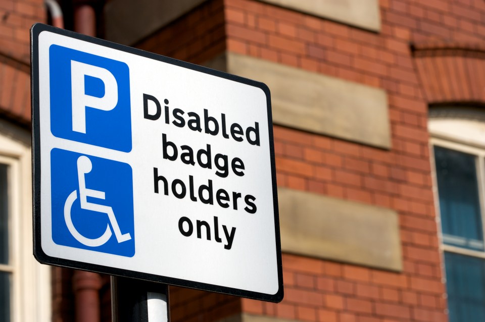 Disabled badge holders only parking sign.
