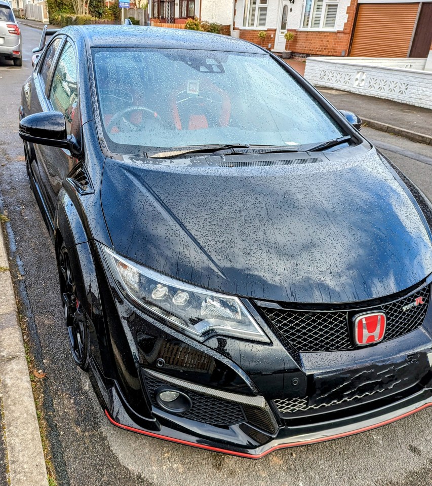 Black Honda Civic Type R parked on a residential street.