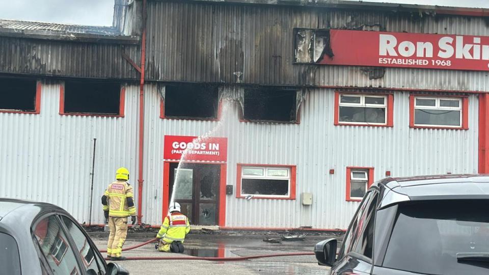 Firefighters extinguishing a fire at Ron Skinner's building.