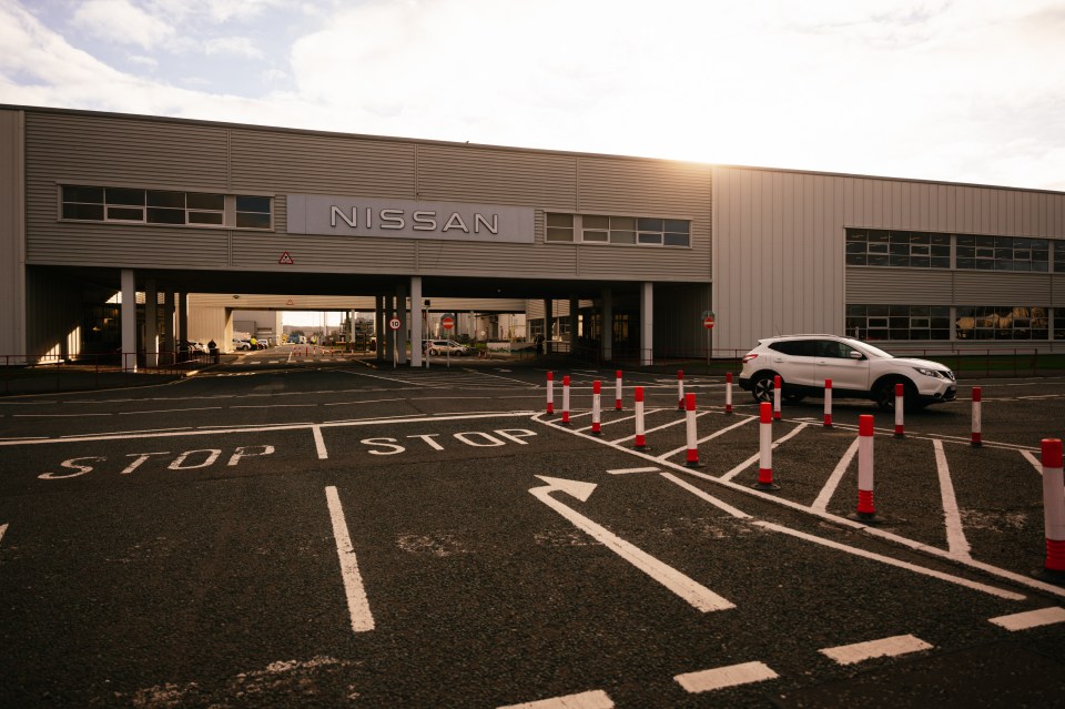 Nissan factory exterior with a white car parked in front.