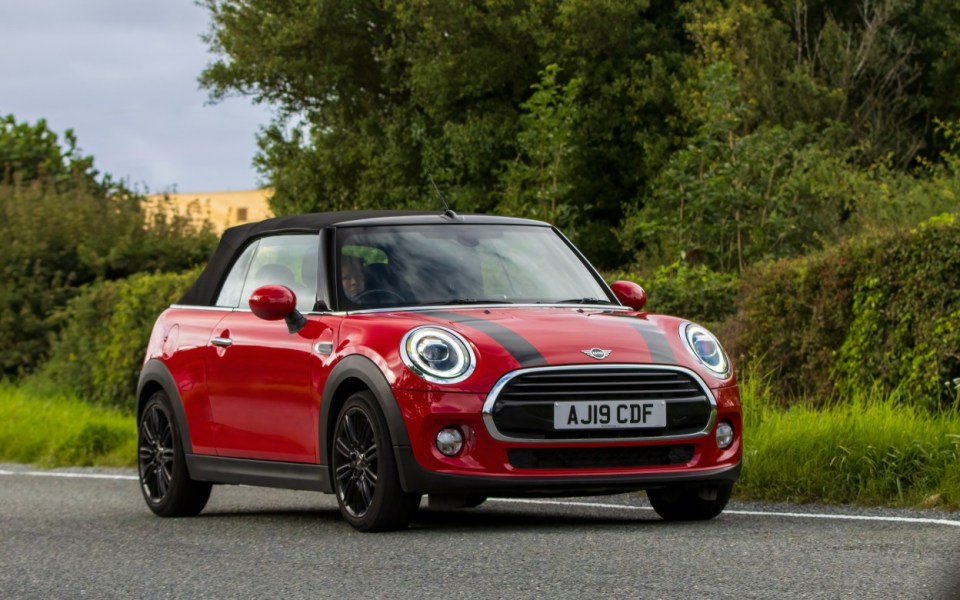 Woburn, Beds, UK - Aug 19th 2023: 2019 red Mini Cooper  car travelling on an English country road.