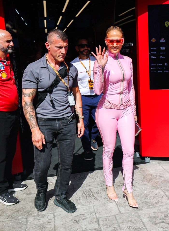 Jennifer Lopez waving at a racetrack.