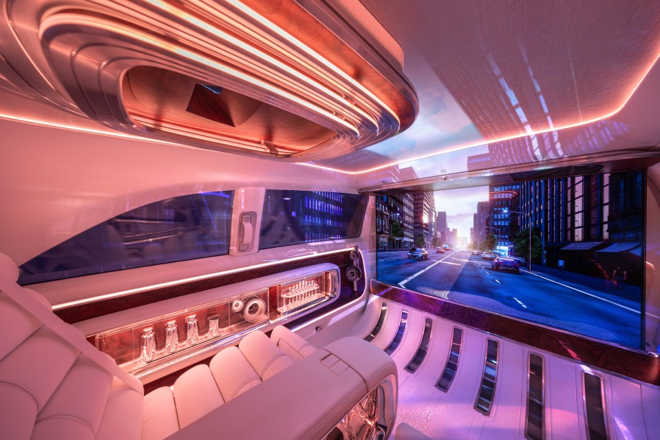 Interior of a Mercedes-Benz Vision V van with a large screen showing a city street.