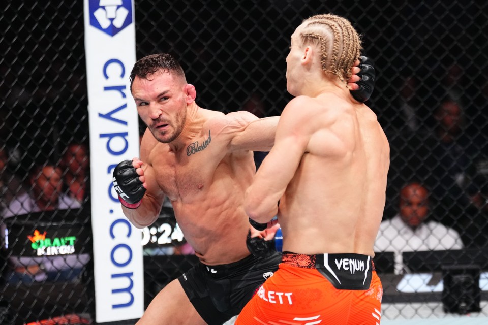 Michael Chandler punches Paddy Pimblett in a UFC lightweight bout.