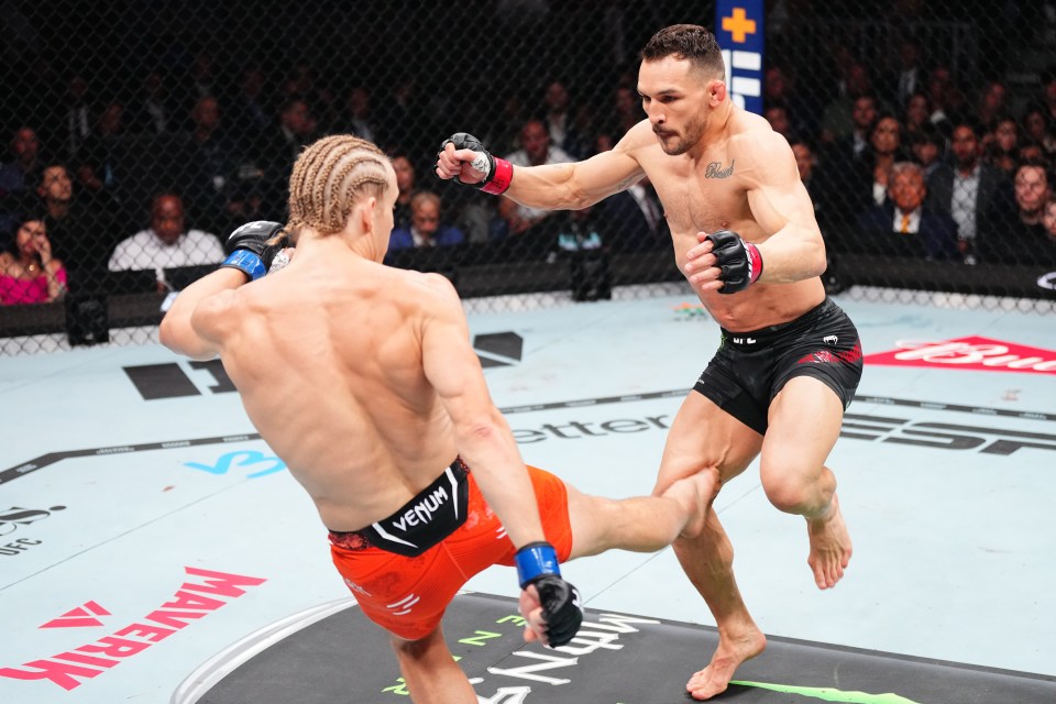 Paddy Pimblett kicking Michael Chandler's leg during a UFC lightweight bout.