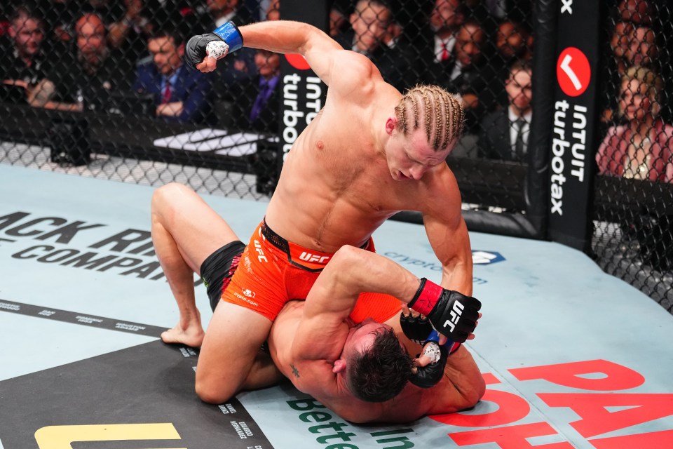 Paddy Pimblett of England punches Michael Chandler during a UFC lightweight bout.