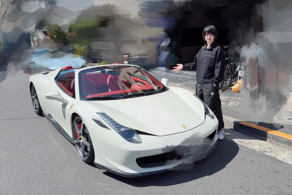Japanese musician Honkon standing next to his white Ferrari.