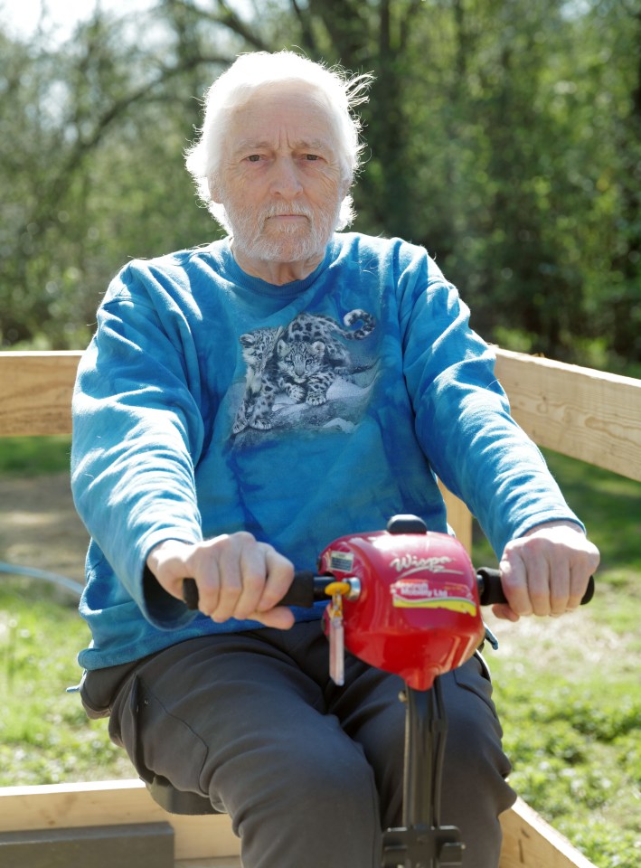 Older man with white hair sitting on a mobility scooter.