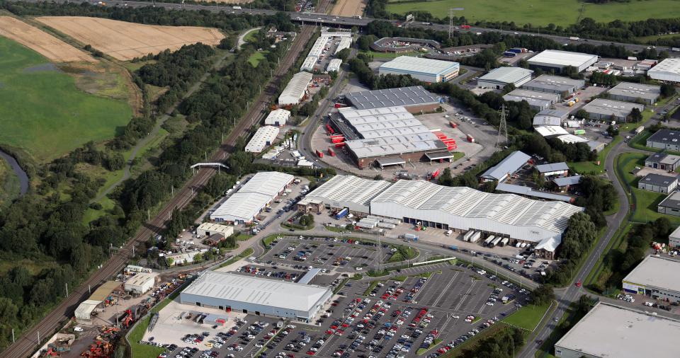 Aerial view of CarShop, Next Distribution, and Royal Mail units in Warrington, Cheshire.
