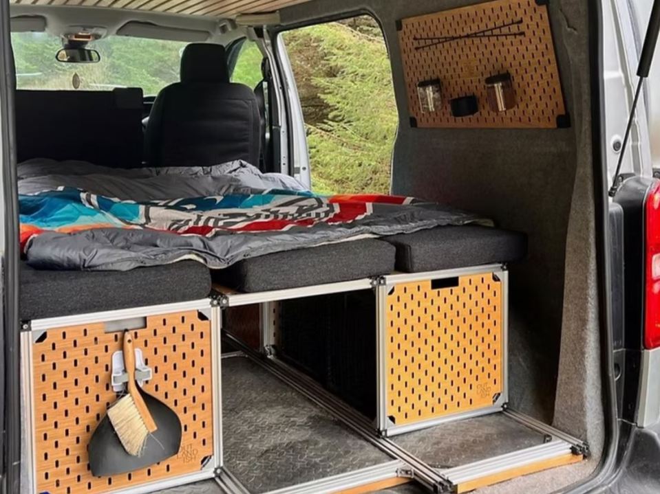 Expedition kit van conversion with bed and storage.