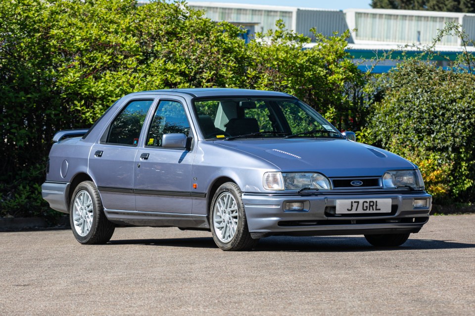Side profile of a blue Ford Escort RS Cosworth Lux Big Turbo.