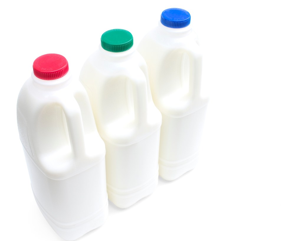 Three milk cartons with red, green, and blue lids.