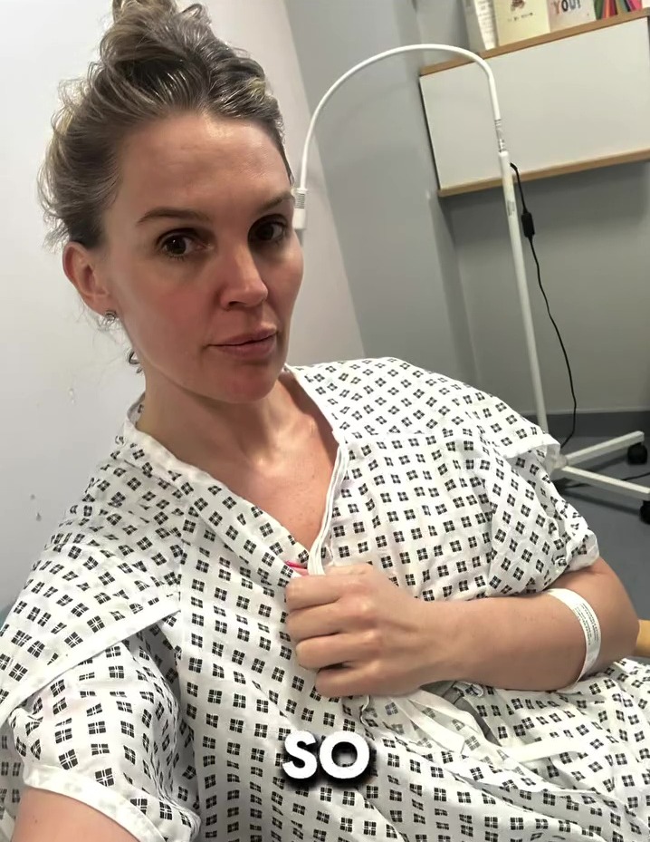 Woman in hospital gown sharing health update.