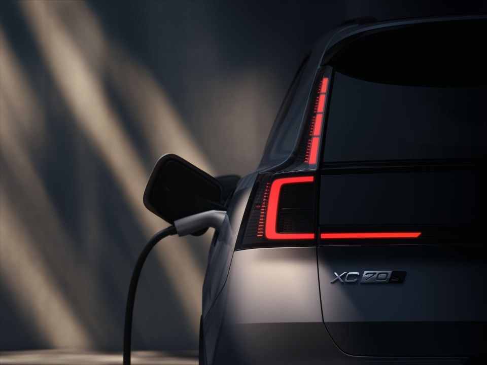 Rear view of a Volvo XC70 plug-in hybrid electric vehicle charging.