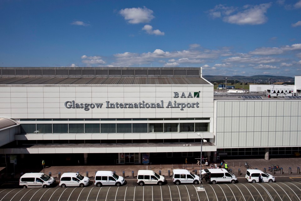 Glasgow International Airport terminal building with taxis parked outside.