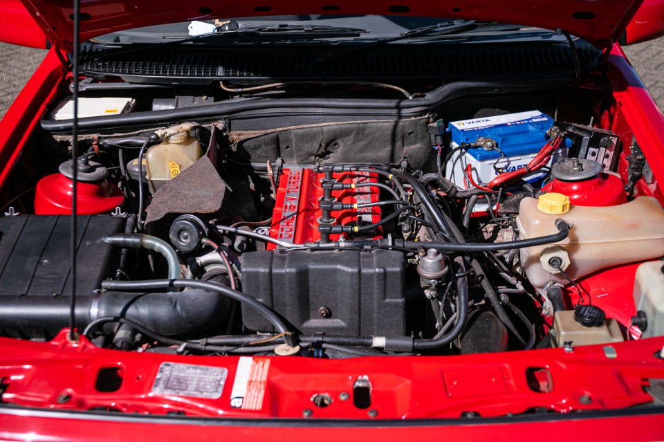 Engine bay of a red Ford Sierra RS Cosworth.