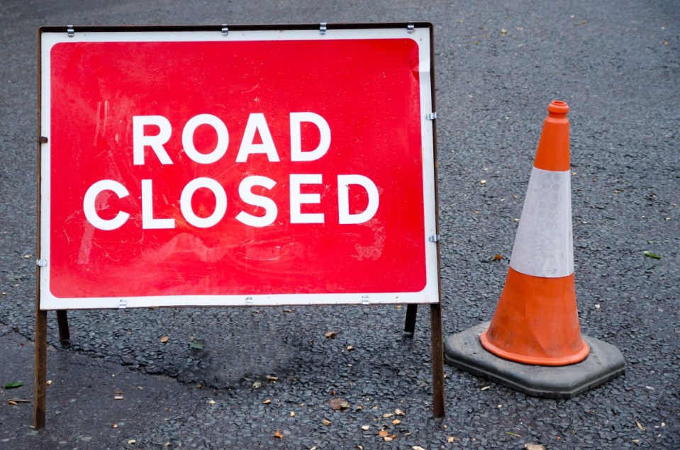 DJF4JC Road closed sign with traffic cone