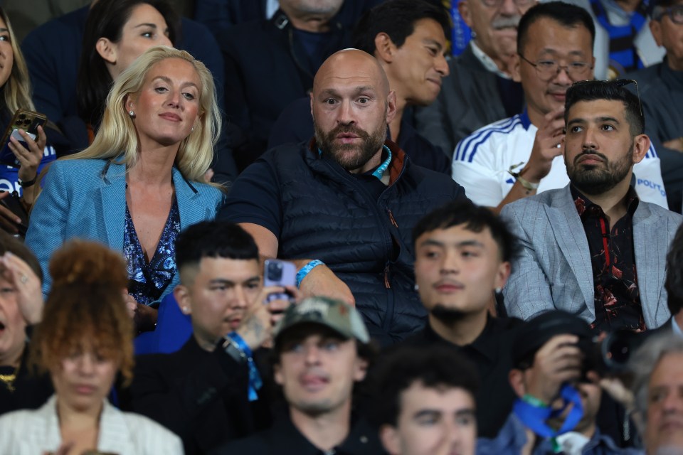 Tyson Fury and his wife in the audience at a sporting event.