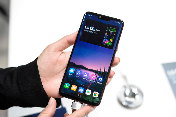 Person holding and displaying an LG G8 ThinQ smartphone.