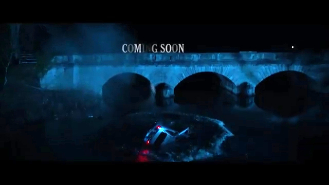 A car submerged in a river under a bridge at night; "Coming Soon" text overlay.