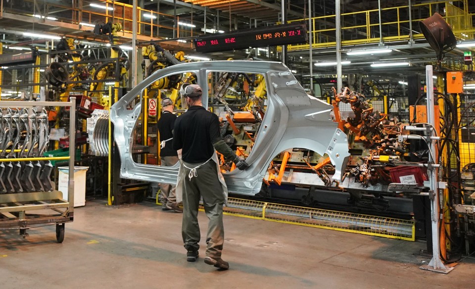 Workers on a car assembly line.